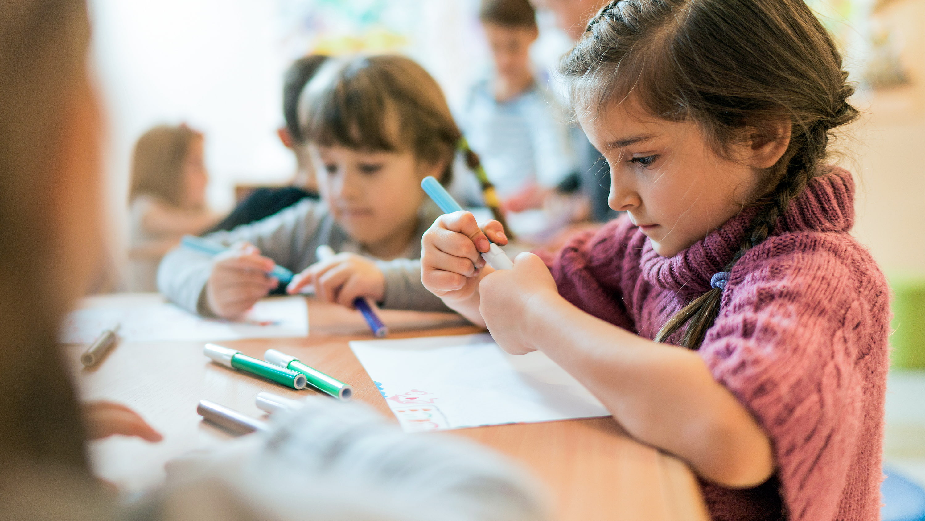 Young girl with classmates in preschool art class. (Photo: Getty Images)