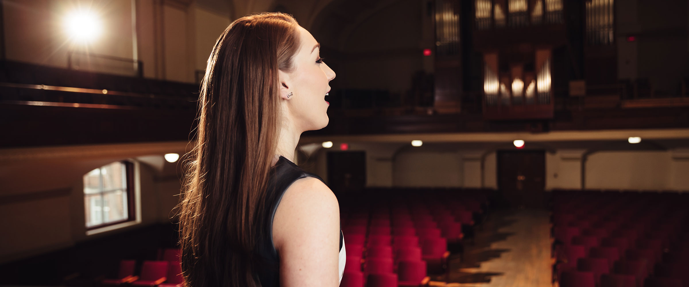 Woman singing in Convocation Hall