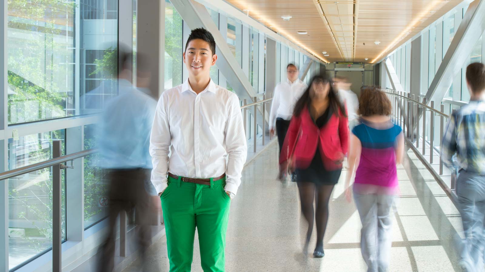 Student standing in a busy pedway