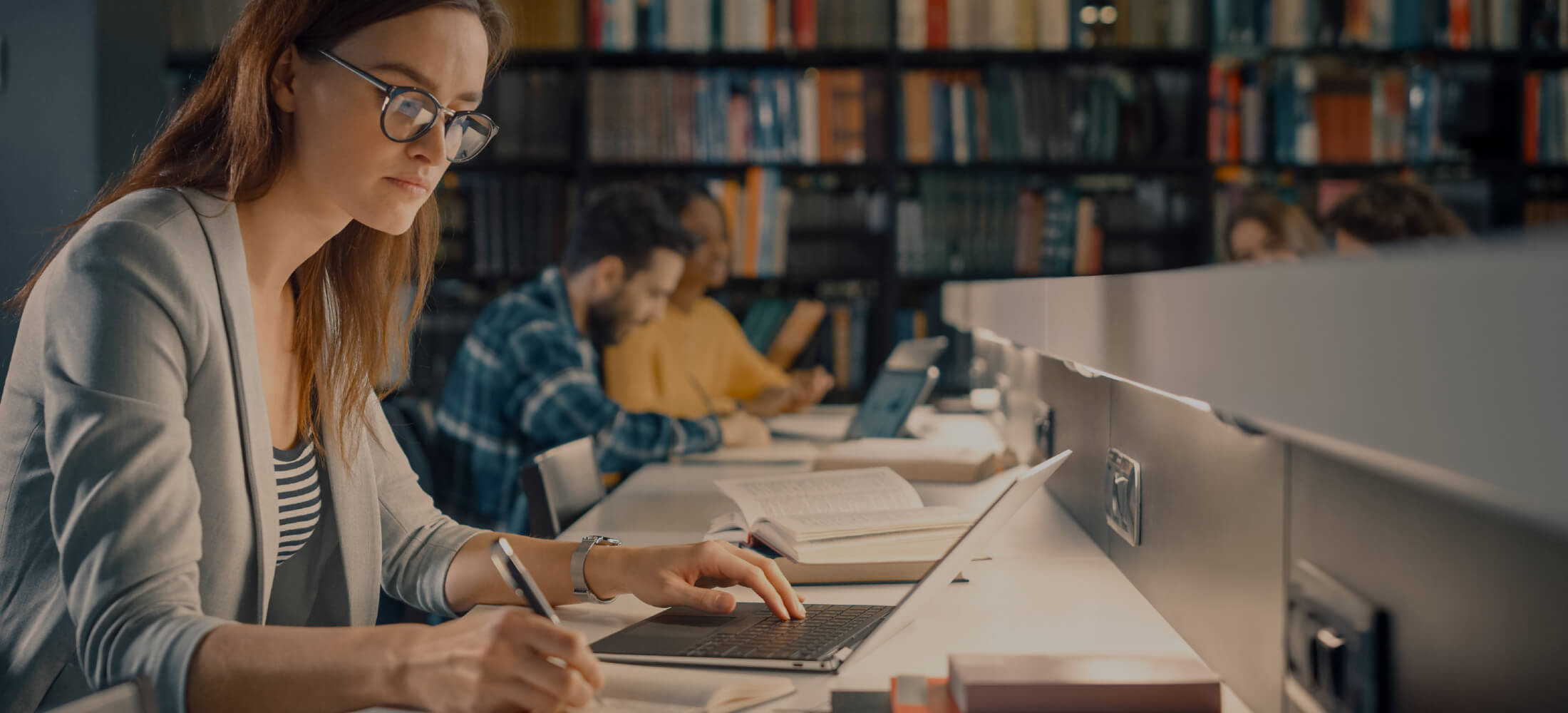 Students writing at a desk