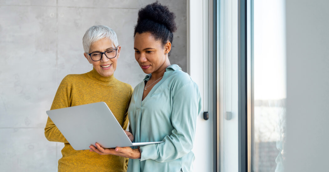 Two people looking at a laptop