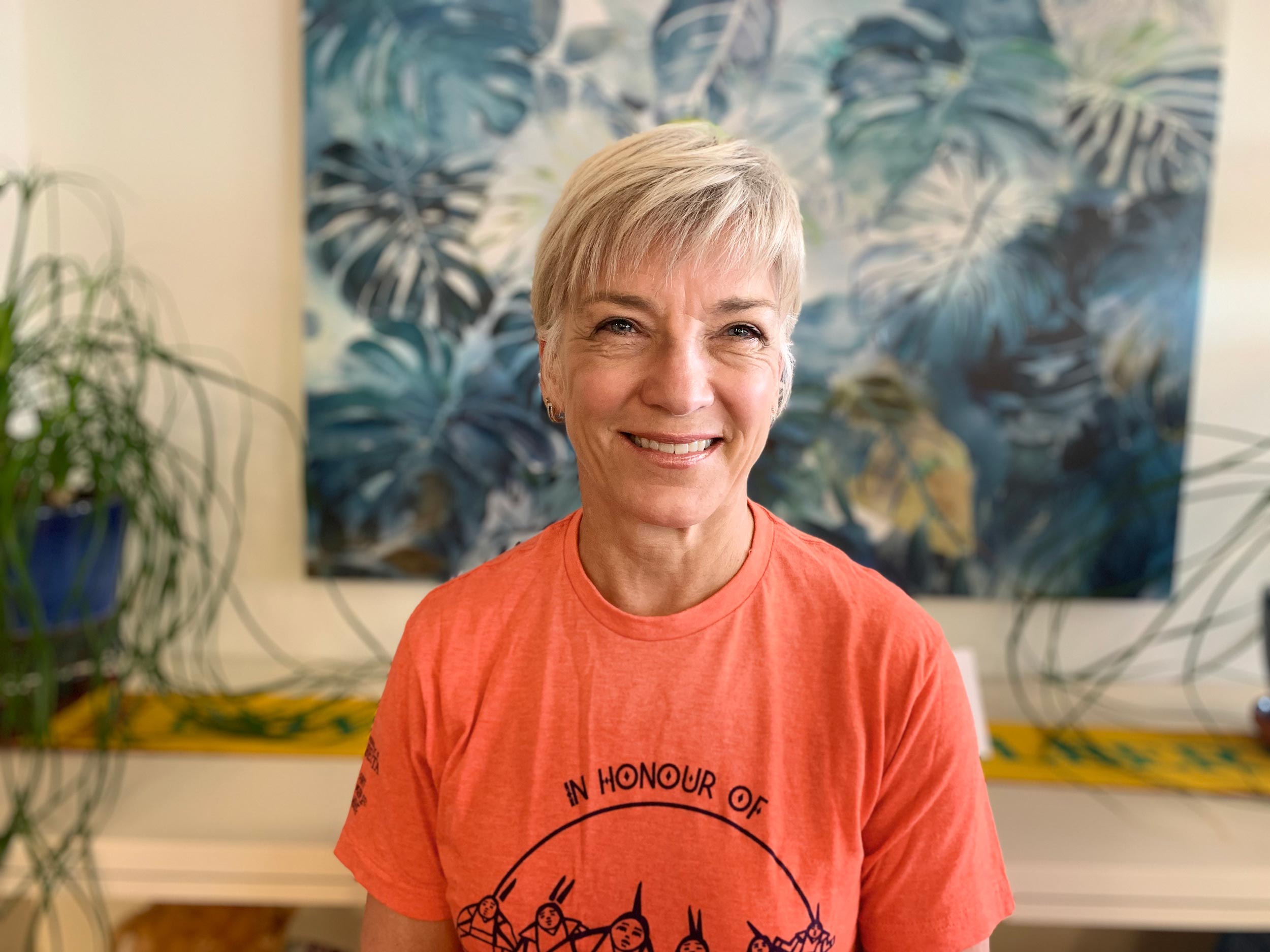 Greta Cummings wearing an orange shirt