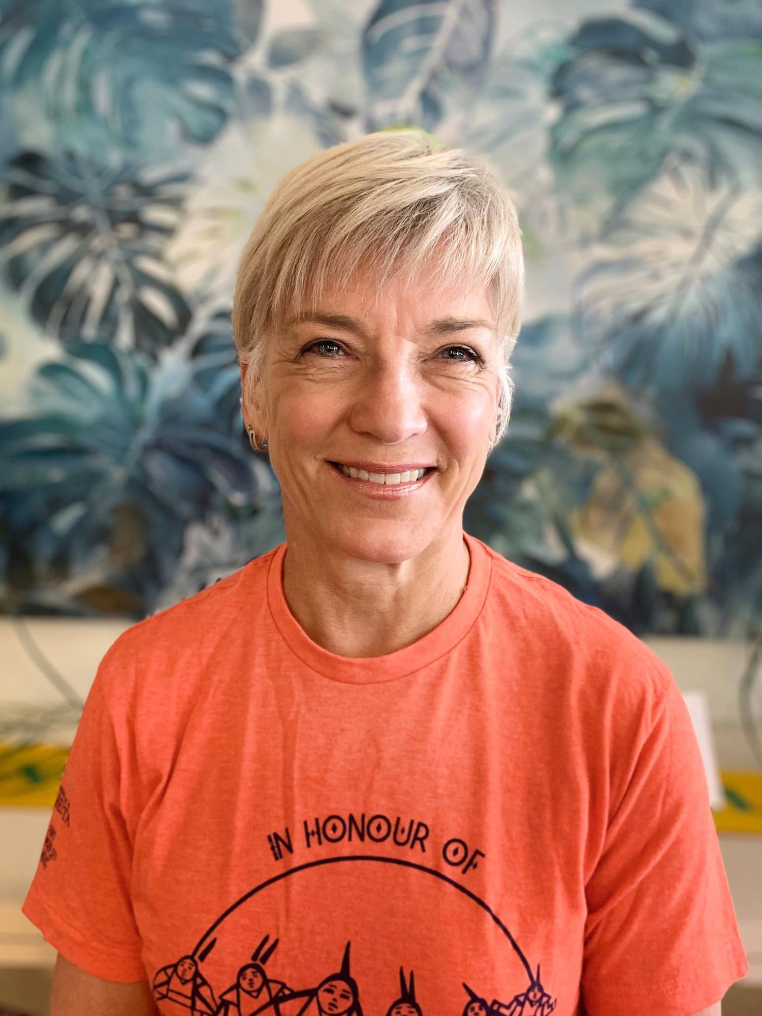 Greta Cummings wearing an orange shirt