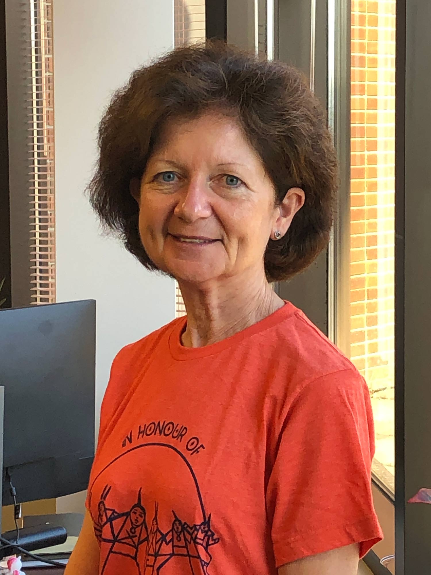 Brenda Hemmelgarn wearing an orange shirt