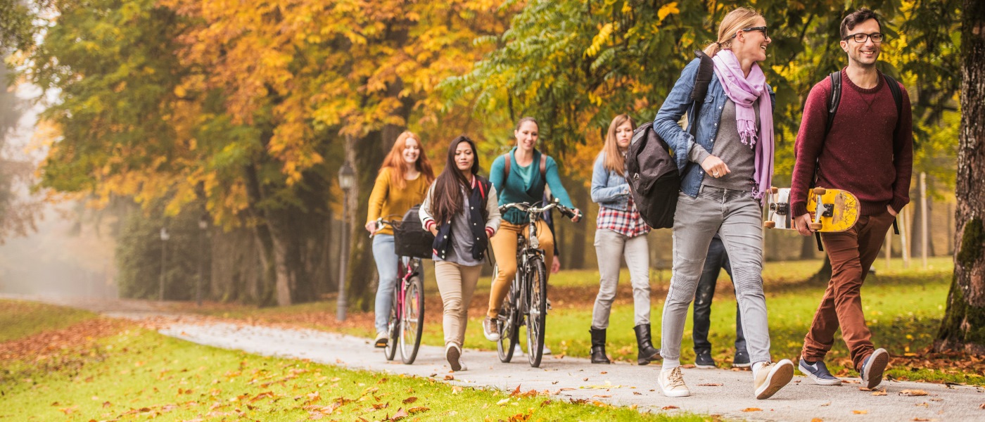 Students walking and biking through a trail