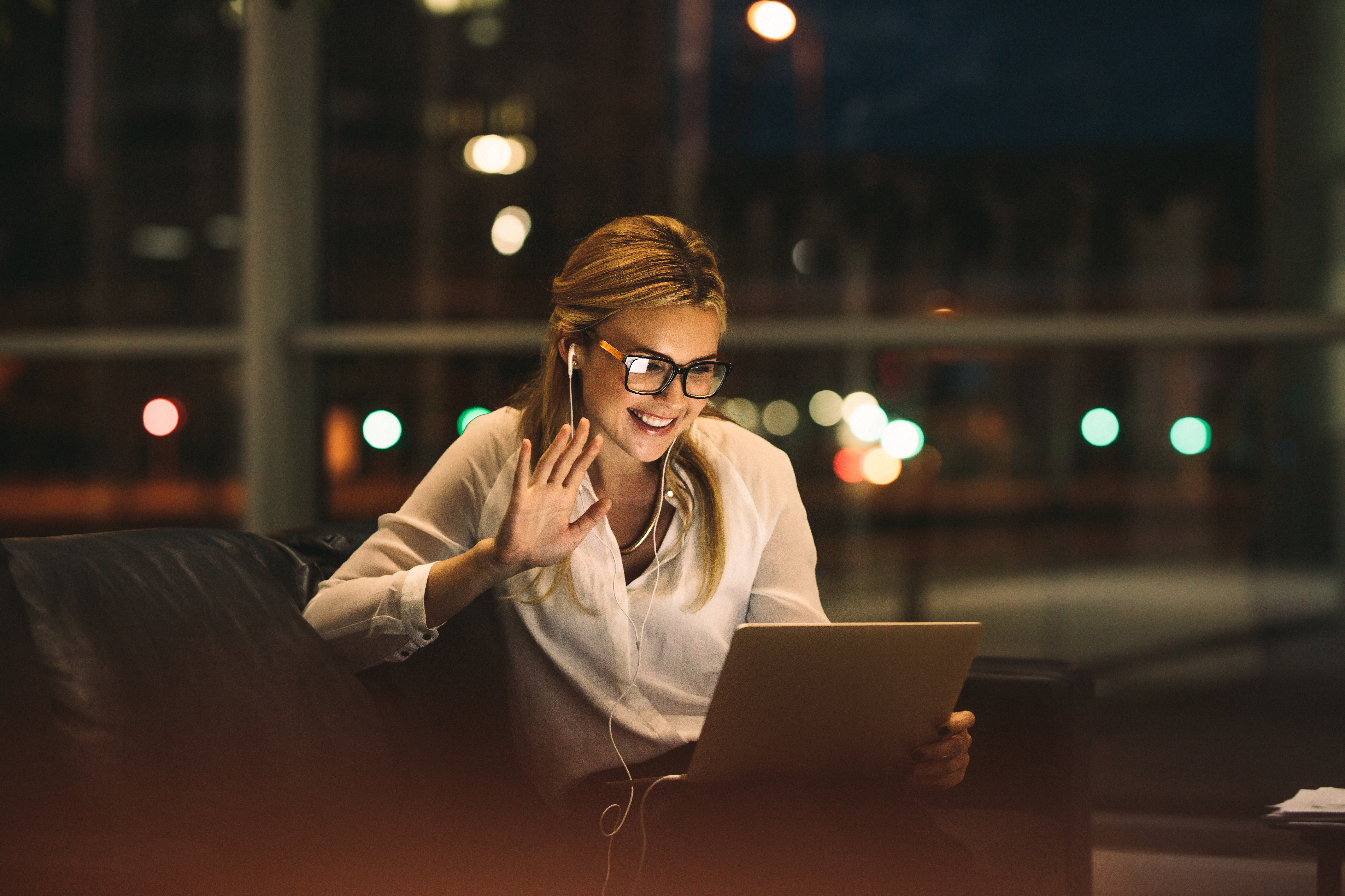 Woman waving at computer