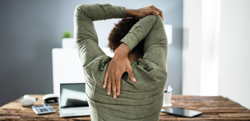 woman stretching at desk