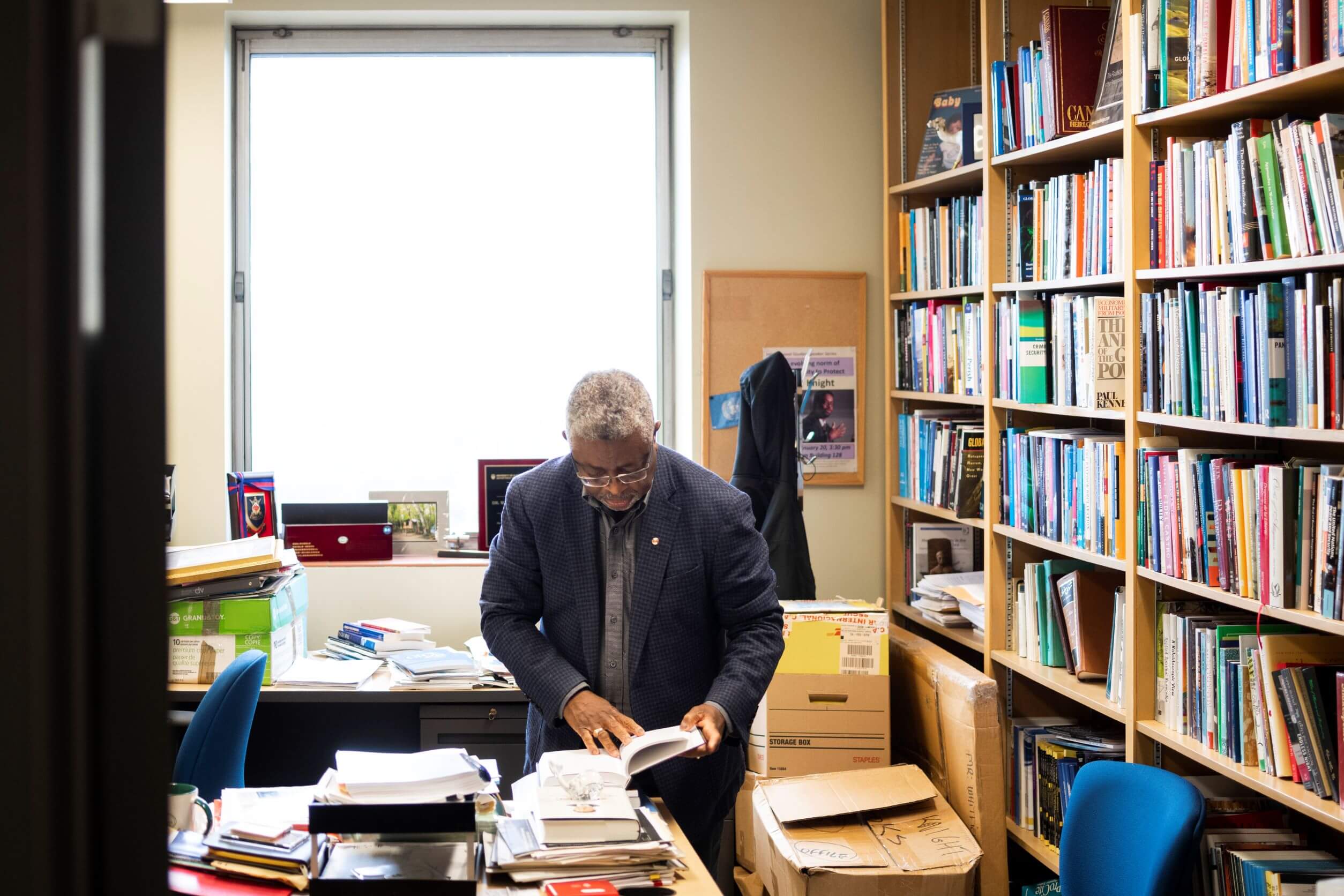 A person looking through books and researching