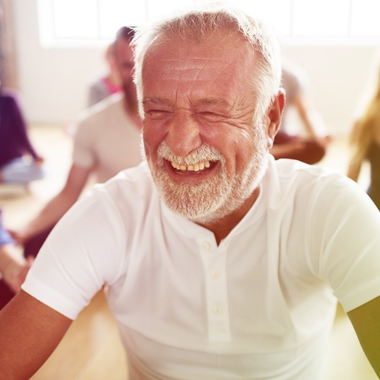 Man smiling while sitting cross legged