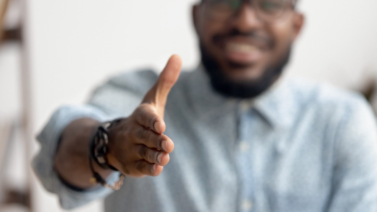 Man holding hand out to shake