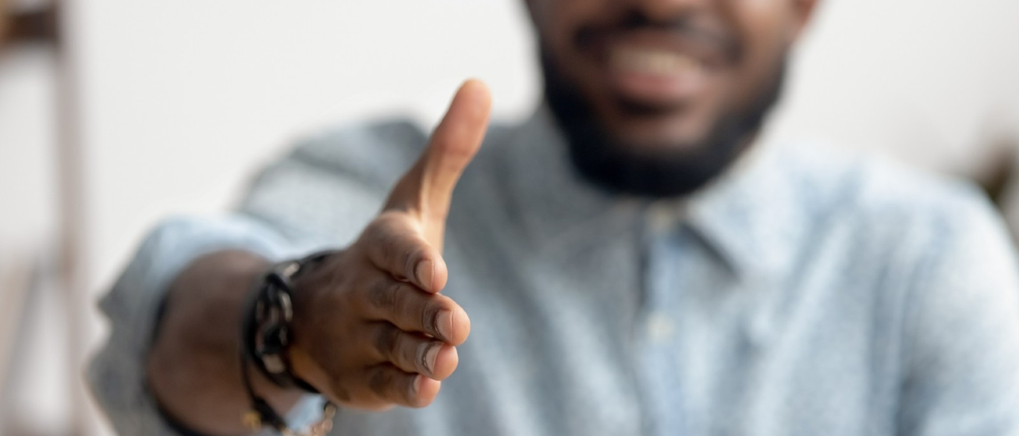 man holding out hand to shake