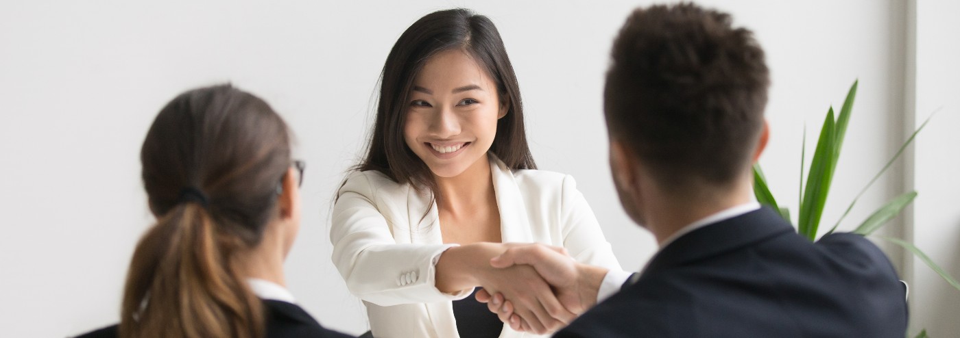 woman-shaking-hands-in-office1400x494.jpg