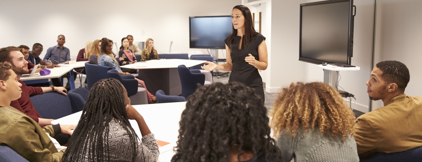 Woman teaching room of students