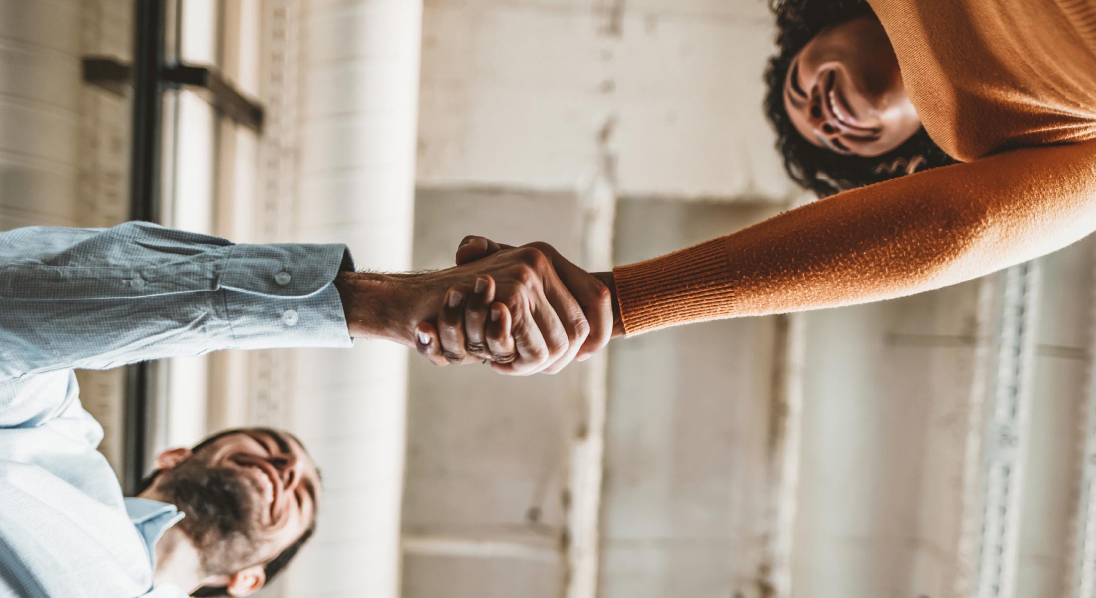 Two coworkers shaking hands