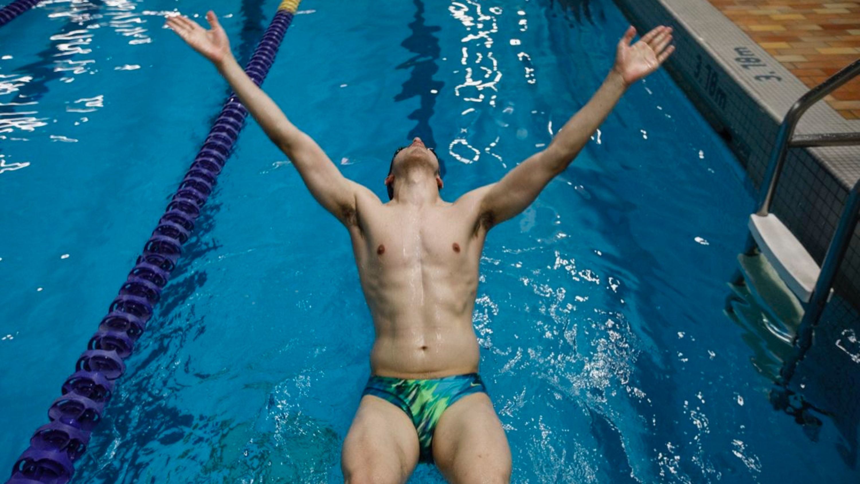 Swimmer falling back into a pool