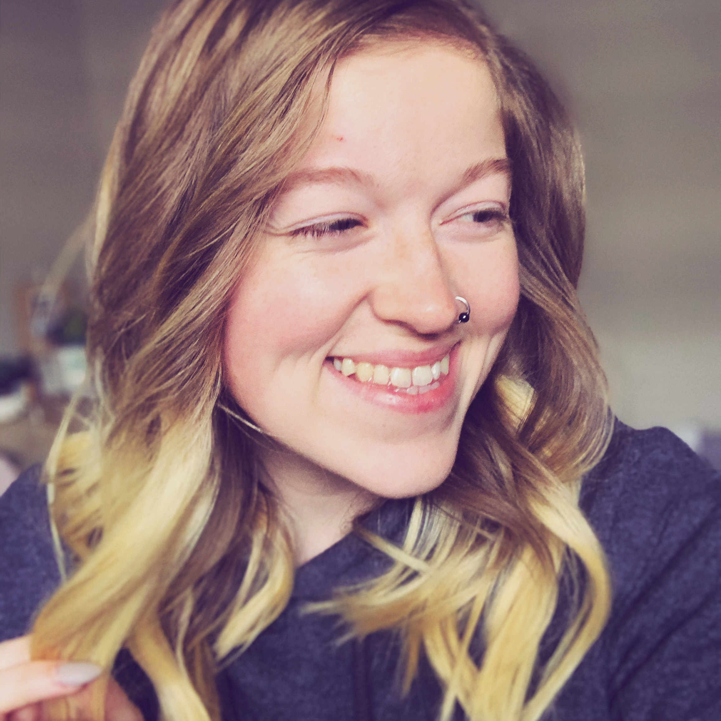 close up angle of blonde woman smiling into camera