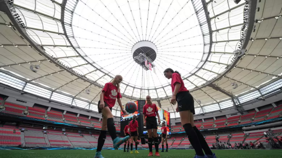 Three soccer players in a stadium