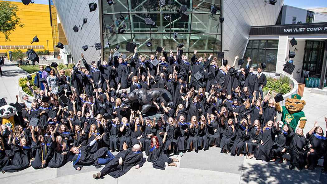 Graduate students outside Van Vliet Complex