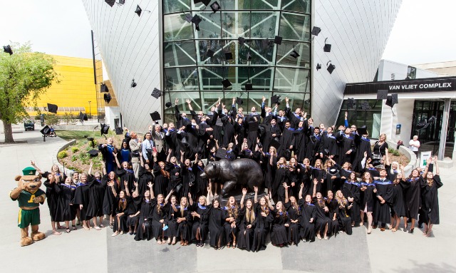 Students in Graduation Gowns Outside