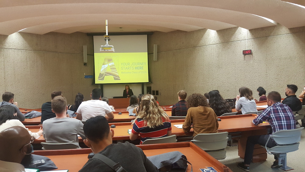 Photo of orientation featuring students listening to Dean Barbara Billingsley