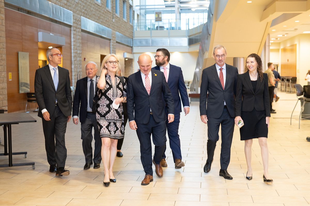 Minister Randy Boissonnault walking with others in the Katz Centre for Health Research