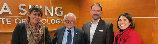 GSK Canada and Dr. Tyrrell pose with a gold Nobel Prize medallion.