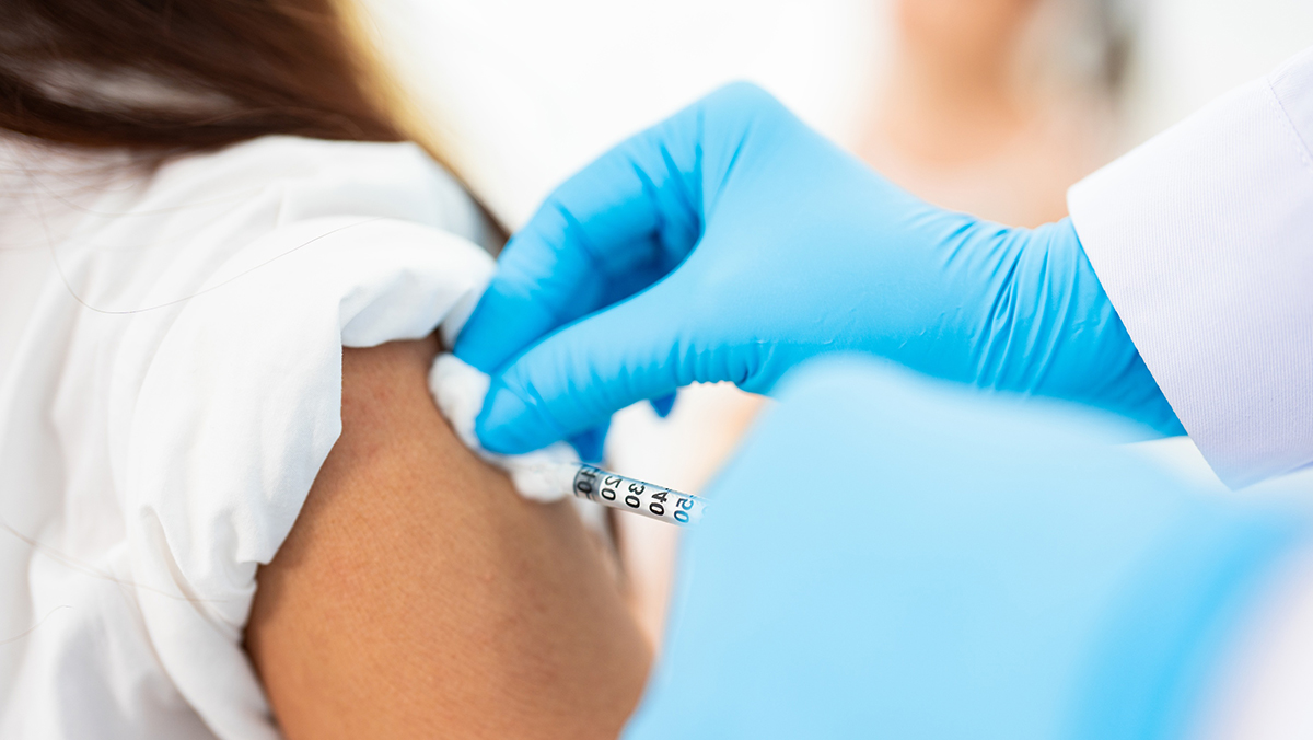 Young girls receives a vaccine shot.