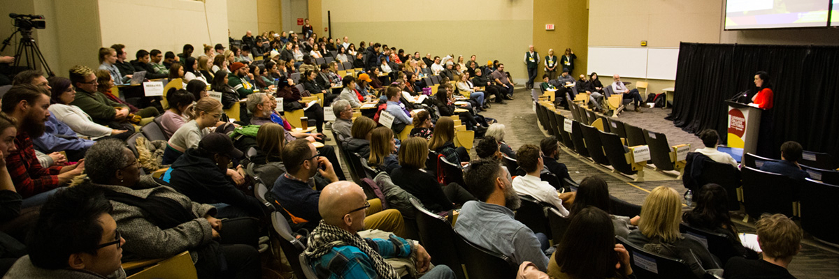 photo of a crowd of people watching a speaker