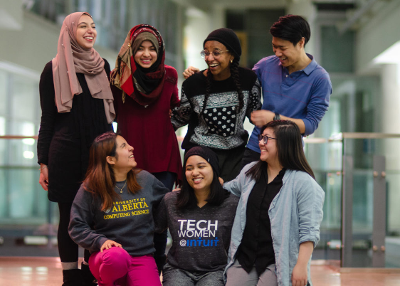 Seven of the student group executives pose together and laugh