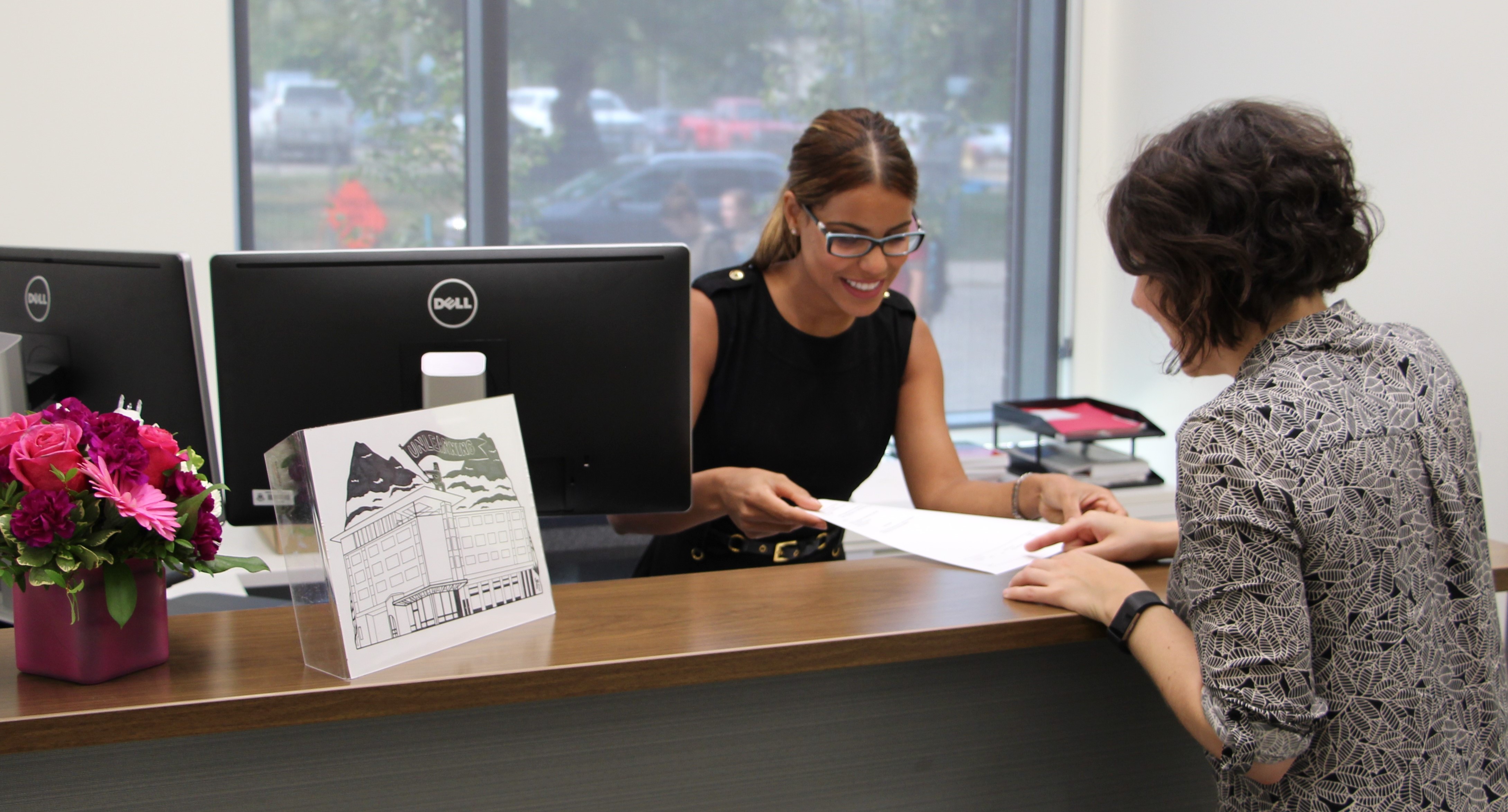 Admin assistant helps a visitor