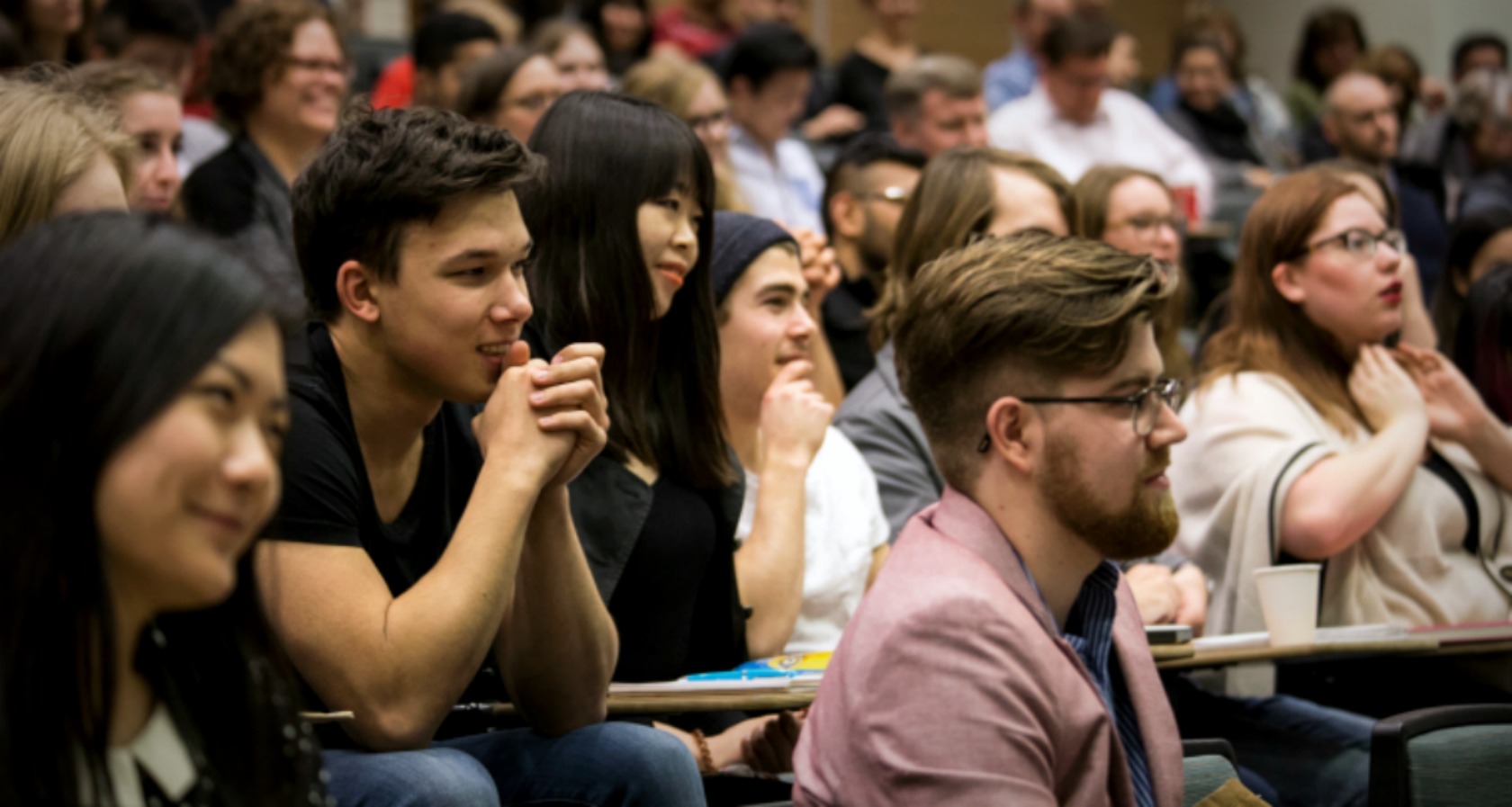 lecture theatre of students paying attention to a speaker