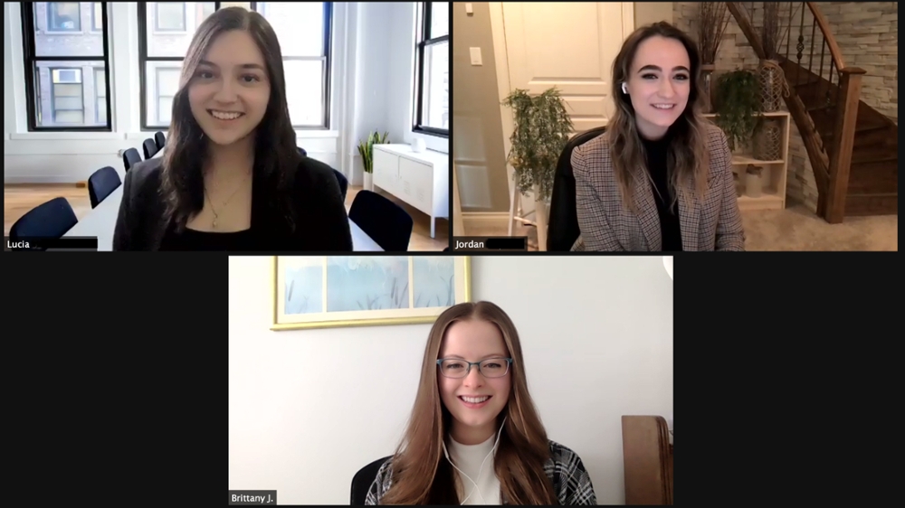 Zoom screenshot showing three young women posing