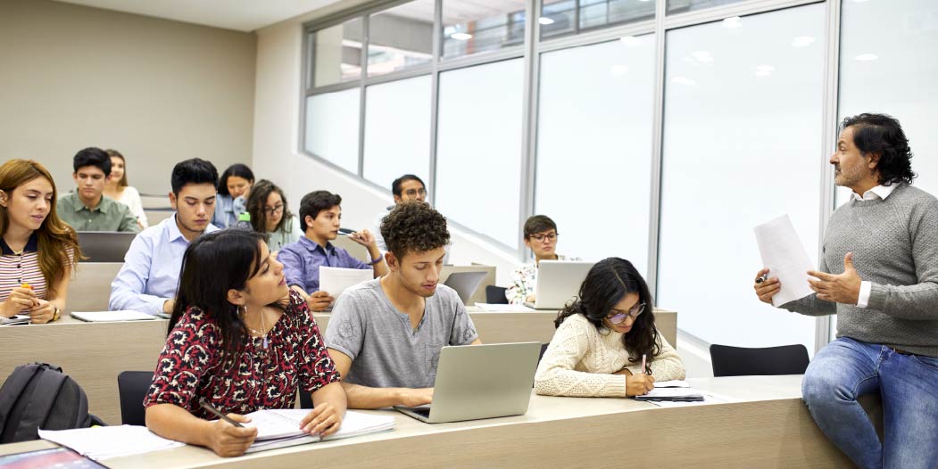 Instructor providing a class in front of a group of students