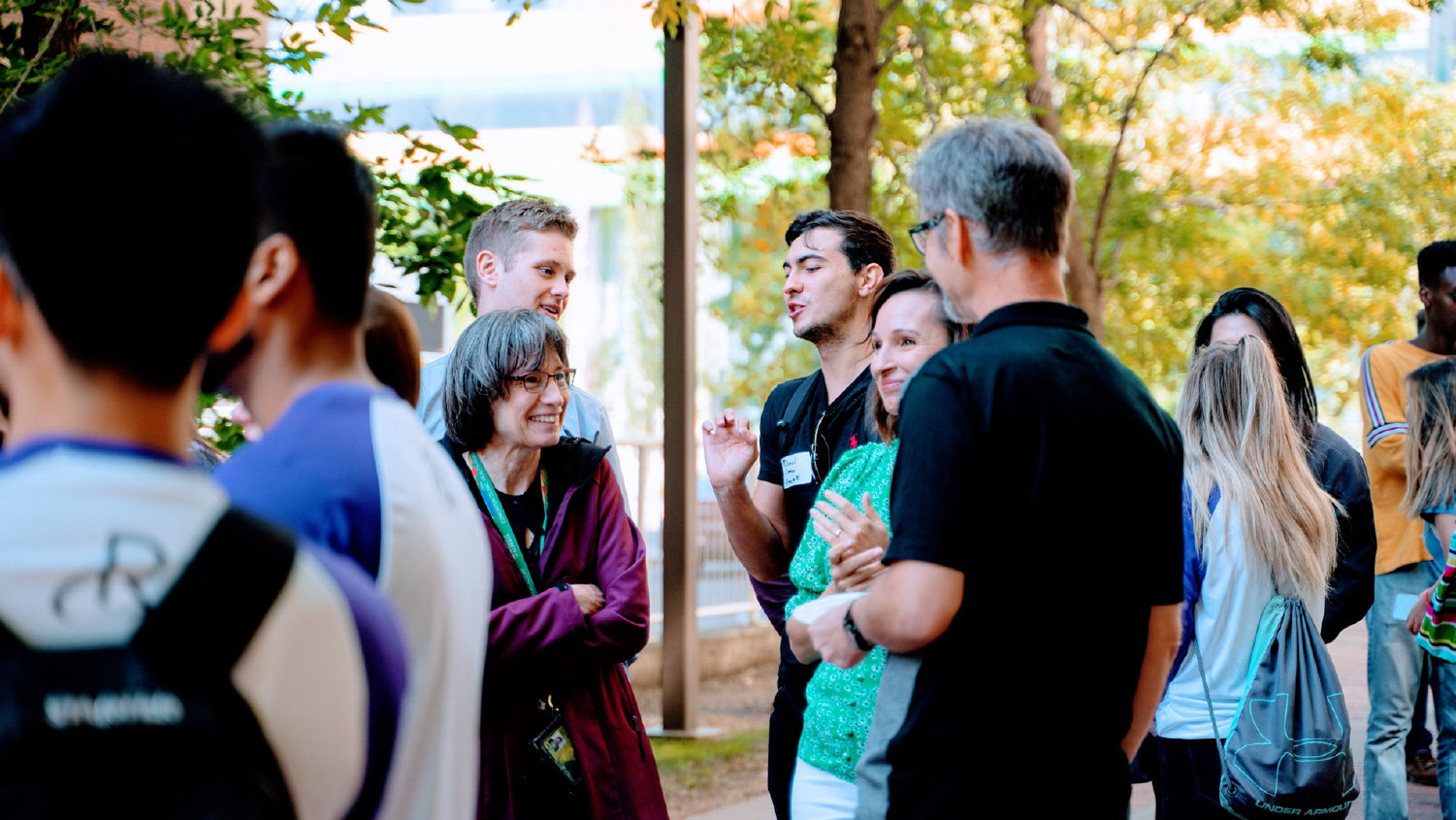 Group of students mingling outside on campus