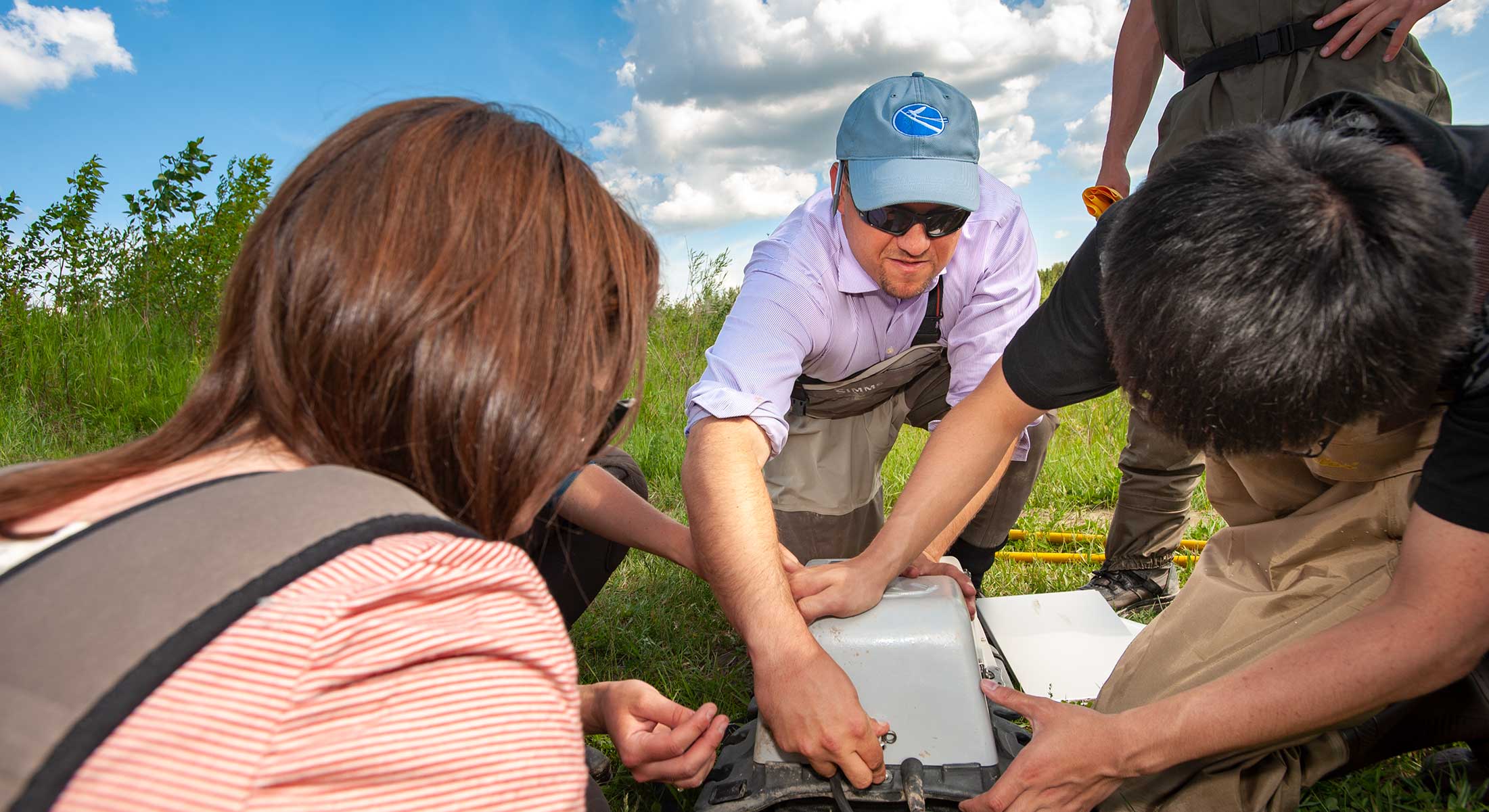 A professor discussing field research with learners