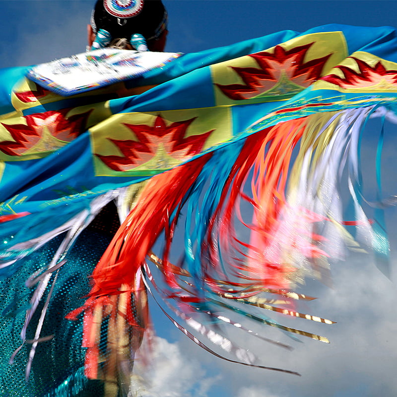 Jade Tootoosis, a Fancy Shawl dancer, mid-dance