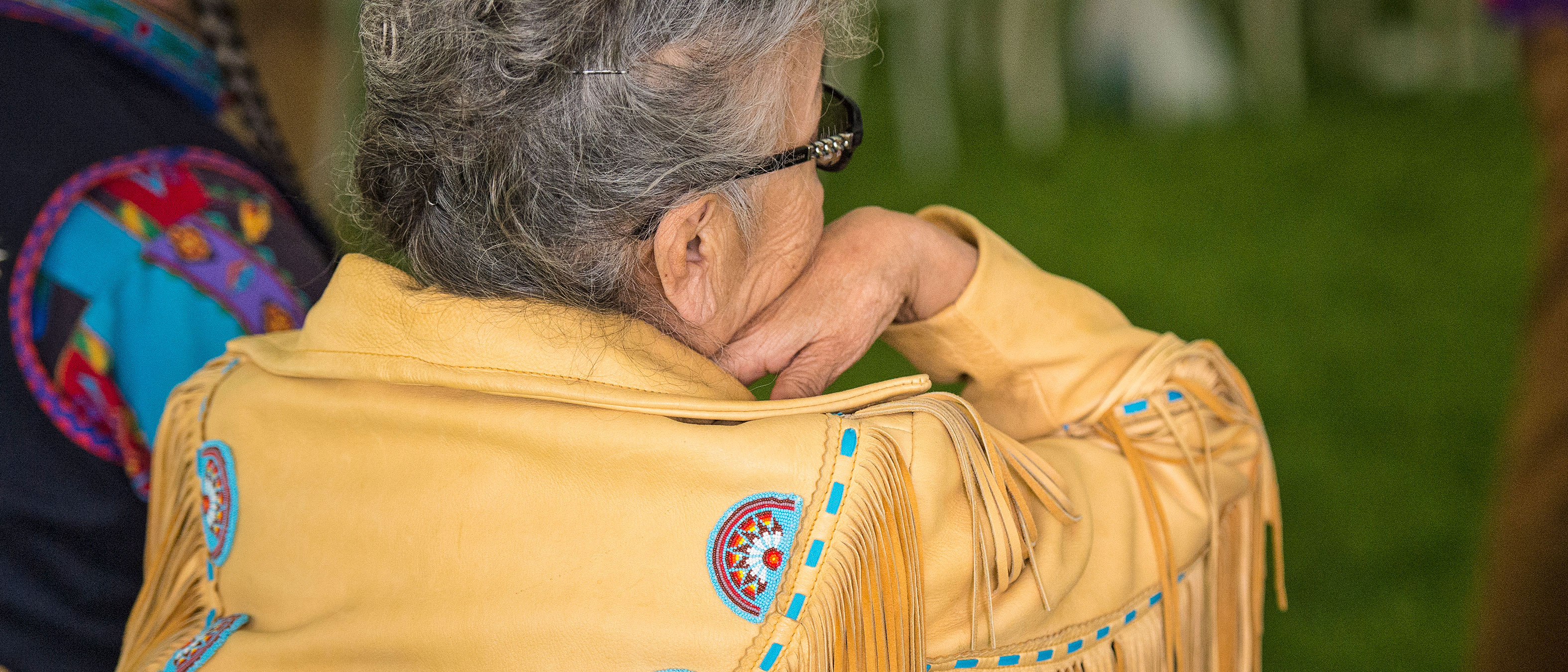 Woman wearing a beaded and fringed jacket