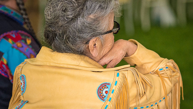 Woman wearing a beaded and fringed jacket