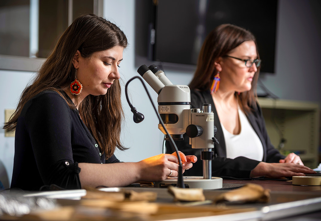 two women using a microscope