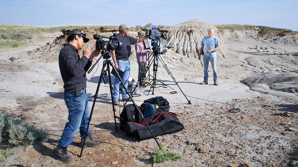 The film crew prepares for a taping of Dr. Phil Currie in Dinosaur Provincial Park for Dino101.