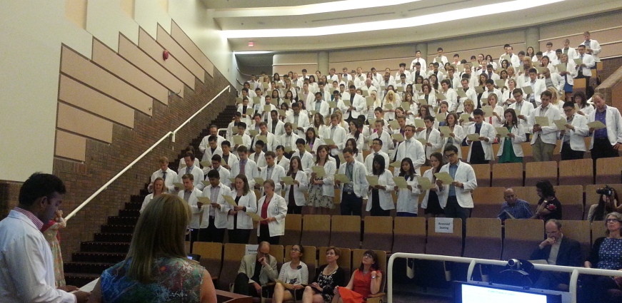 Angelo Gunanayagam, representative for the Class of 2015, leads the reading Pledge of Student Conduct