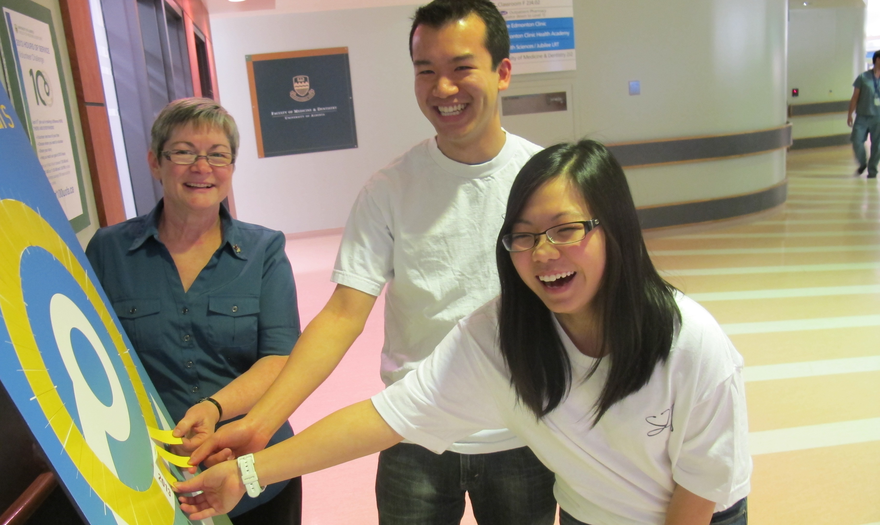 Deb Key, Phil Quon and Kerry Wong place the last few markers on the 2,013 Hours of Service meters.