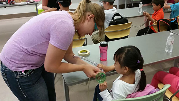 Medical student works with a camper during Rockin' Docs 2014