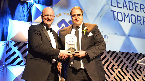 Don Scott, minister of Innovation and Advanced Education, presents Matthew Benesch with the 2014 Leaders of Tomorrow award.