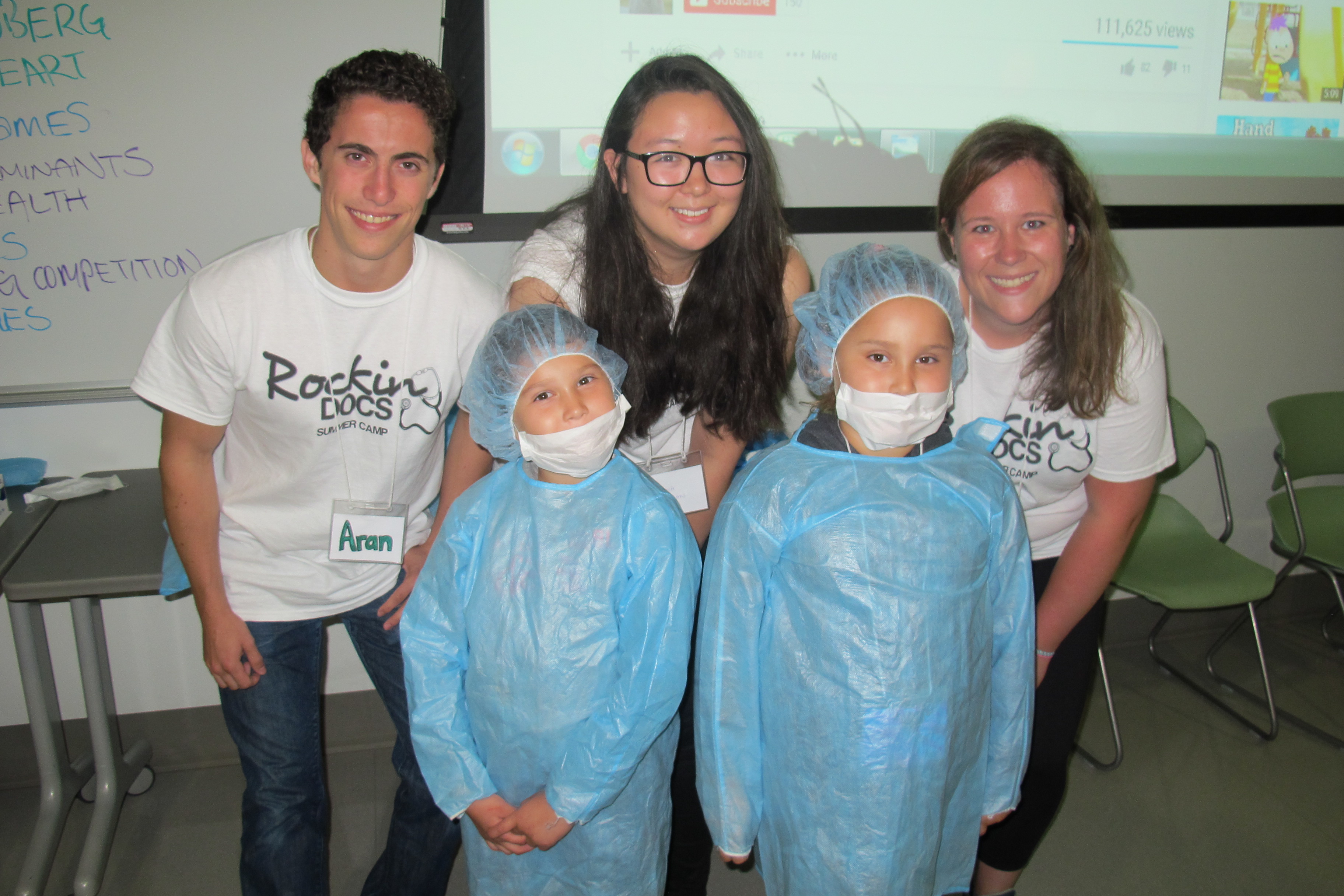 Rockin' Docs co-ordinators Aran Yukseloglu, Shauna Regan and Jennifer Weekes pose with campers Zofia and Zoe Iron.