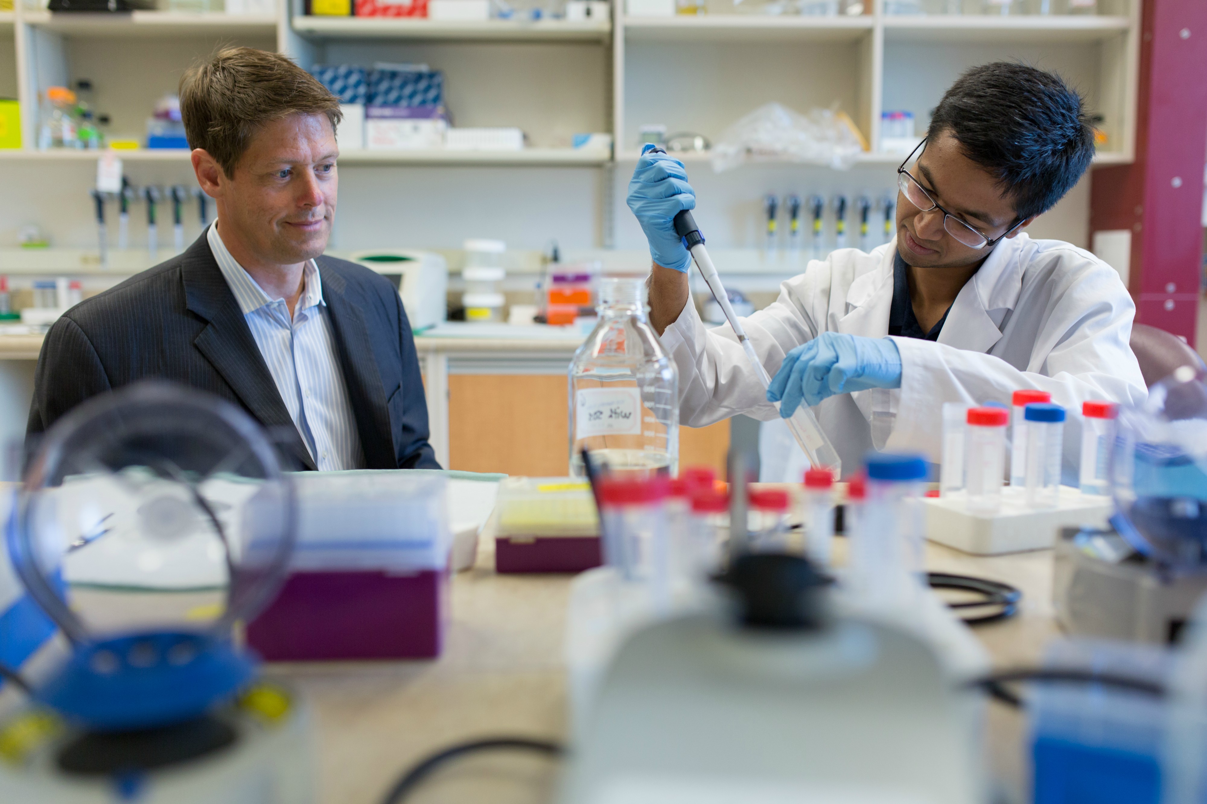 John Lewis (left) oversees work in his lab at the University of Alberta