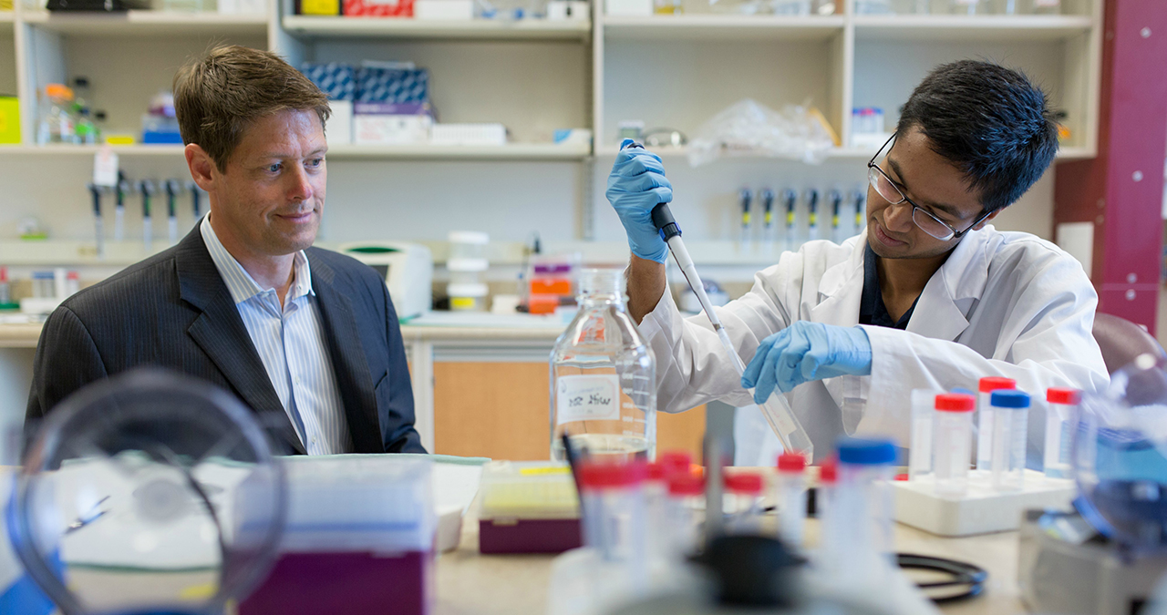 John Lewis watches work taking place in his lab