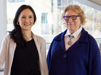 Tibetha Kemble and Jill Konkin smiling next to a window