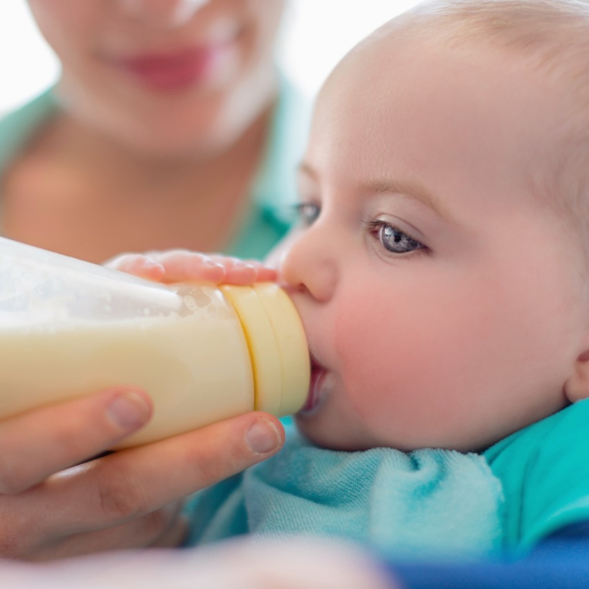 Infant drinks formula from a bottle