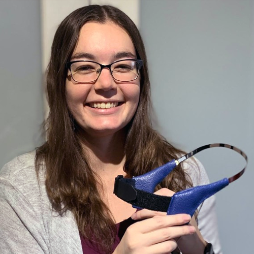 Cassandra Wilkinson holds a prototype EEG headband